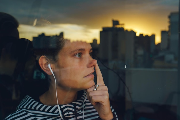 Photo close-up of woman picking nose seen through window