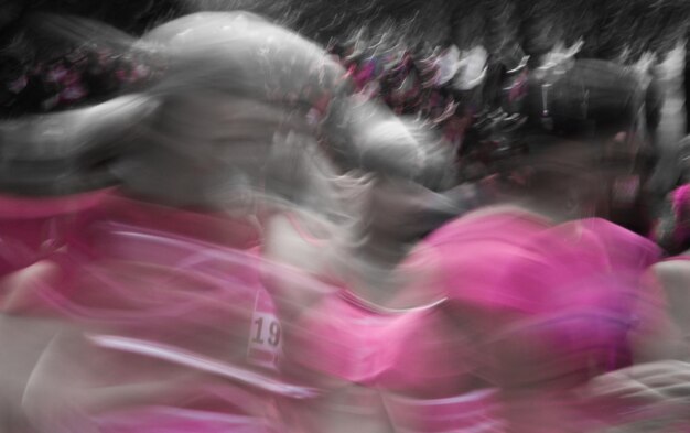 Close-up of woman in pink background