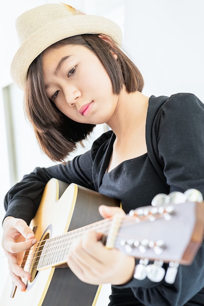 Close up woman playing guitar 