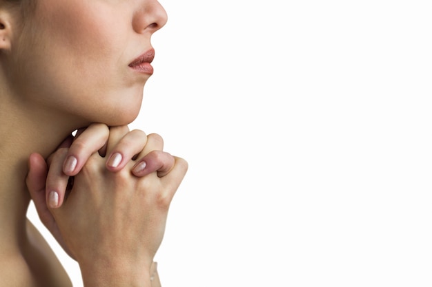 Close-up of woman praying with joining hands 