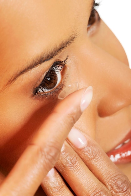 Close-up of woman putting contact lens