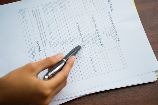 Photo close-up of woman reading application form