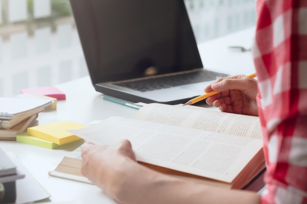 close-up of woman reading book on table