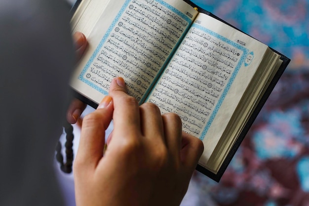 Photo close-up of woman reading koran