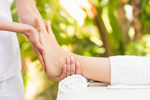 Close-up of a woman receiving foot massage