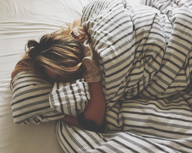 Photo close-up of woman relaxing on bed at home