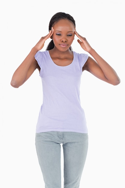 Close up of woman rubbing her temples on white background