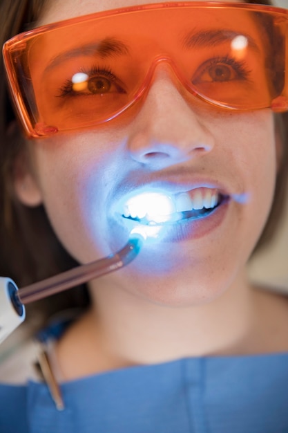 Close-up of a woman's face going through dental treatment