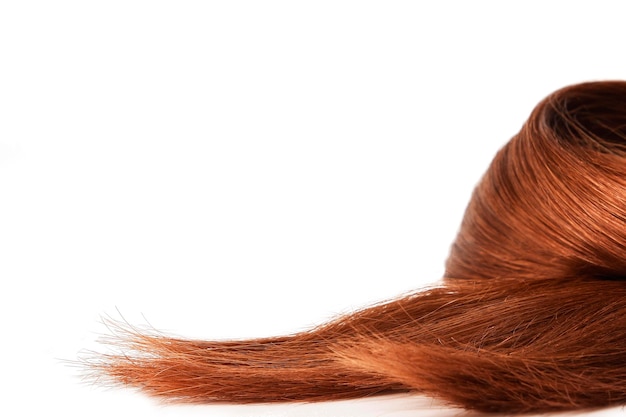 A close up of a woman's hair with a red hair color