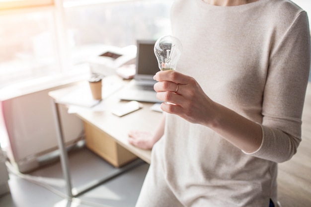 Close up of woman's hand holding a bulb