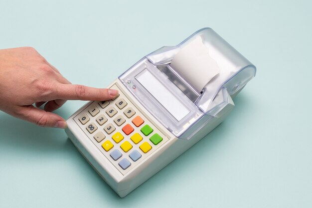 Close-up of a woman's hand pressing her finger in a cash register button