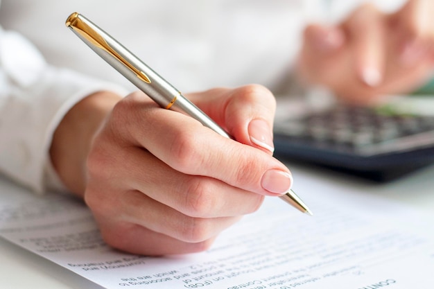 Close up of a woman signing contract