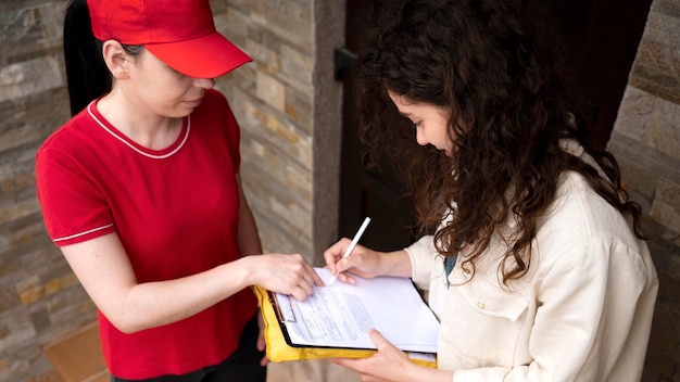 Close up woman signing document