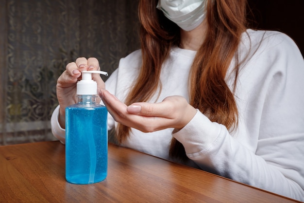 Close up woman spraying hand sanitizer