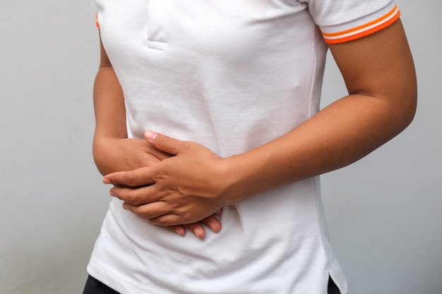 Close-up Of Woman Suffering From Stomach Ache