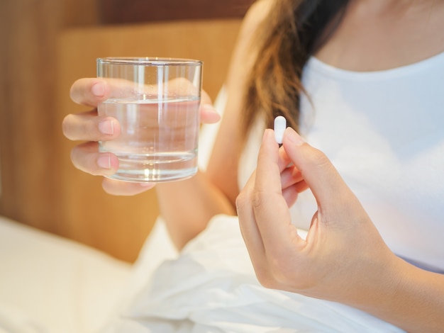Close up of woman taking in pills, Medicine, health care concept.