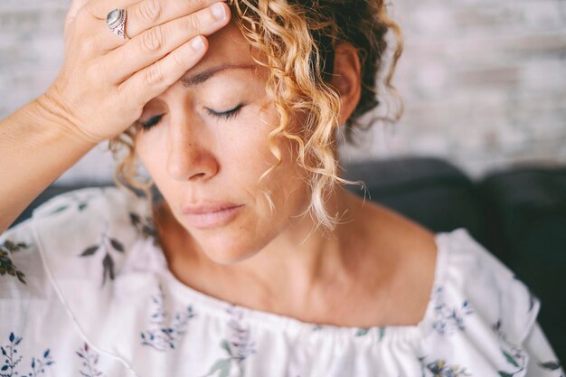 Photo close up of woman touching his front for head ache or stress disease healthcare and health medicine concept lifestyle headache female people with fever and infouenza illness condition