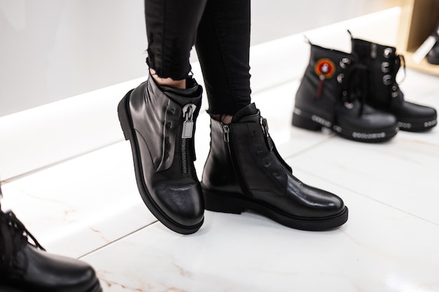 close up of woman trying on black boots