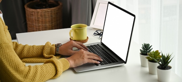 Close up on woman typing on laptop