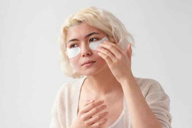 Close up woman using eye patches