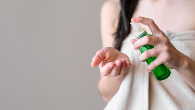 close-up woman using hair product