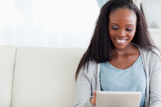 Close up of woman using her tablet on sofa