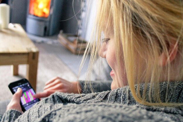 Close-up of woman using mobile phone at home