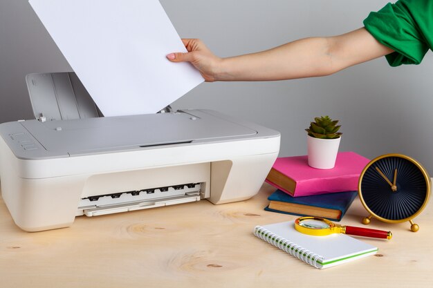 Close up of woman using a printer machine