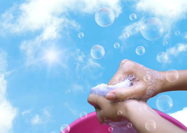 Photo close-up of woman washing clothes against sky