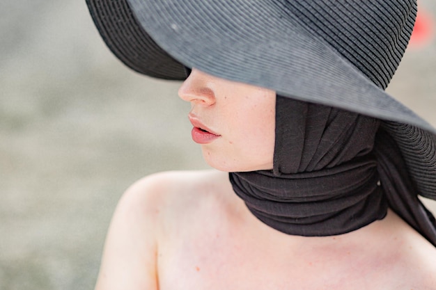 Close-up of woman wearing black hat