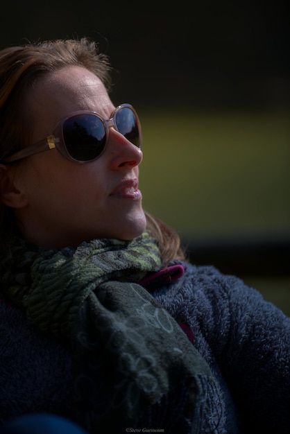 Close-up of woman wearing sunglasses and scarf