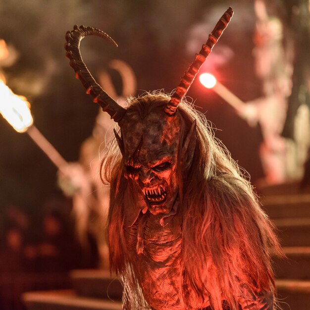 close-up of woman with arms raised at night