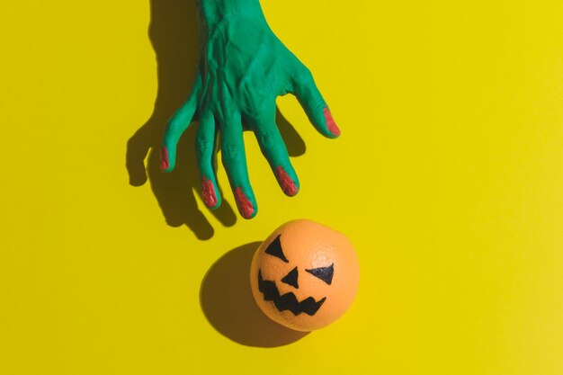 Close-up of woman with ball against yellow background