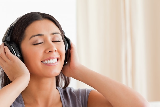 close up of woman with closed eyes and earphones