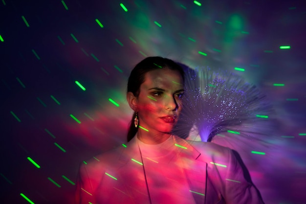 Close-up of woman with multi colored lights on face