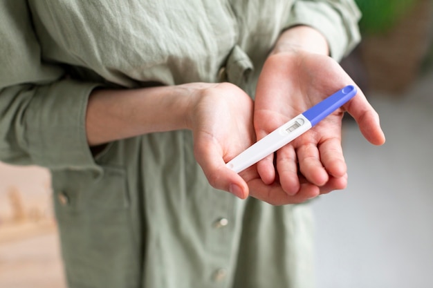 Close-up woman with pregnancy test