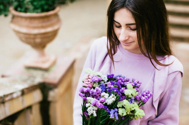 Foto close-up di una donna con fiori viola