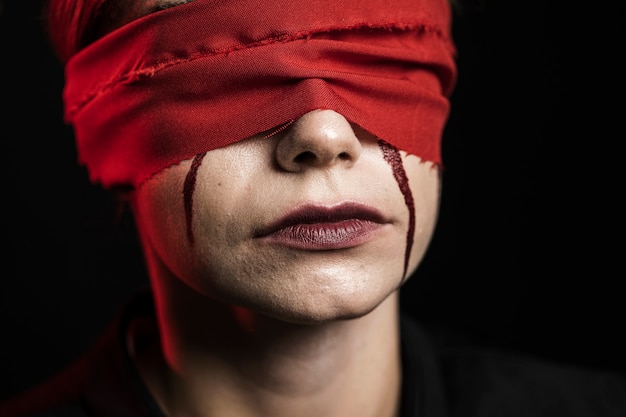 Close-up of woman with red blindfold