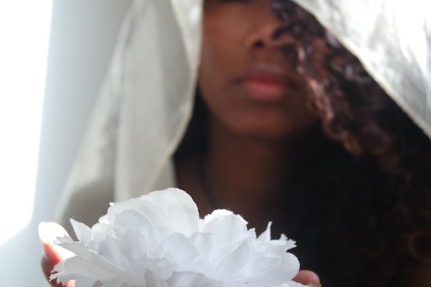 Close-up of woman with white flower