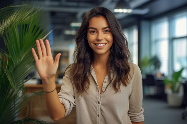 Close up of a woman at work smiling at her workplace and giving a high five to the camera