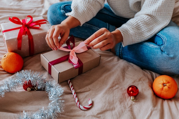 close up woman wrapping gifts