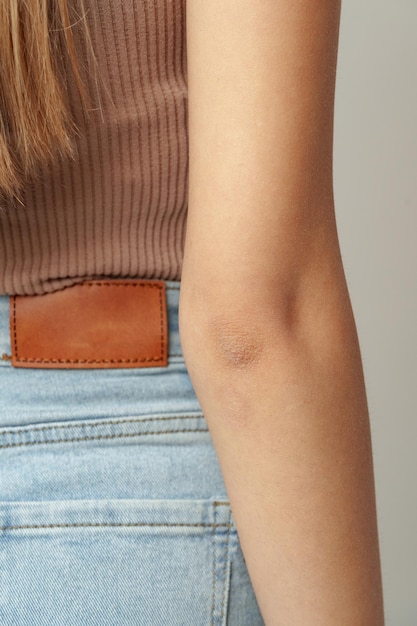 Close up of womans hand against gray background in studio