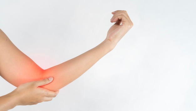 写真 close up womans hand holding her elbow elbow pain concept