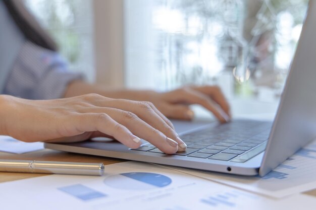 Close-up of a womans hand pressing on the laptop keyboard world of technology