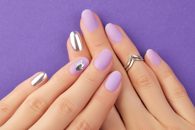 Premium Photo | Close up womans hand with matte lavender nail design on  purple background