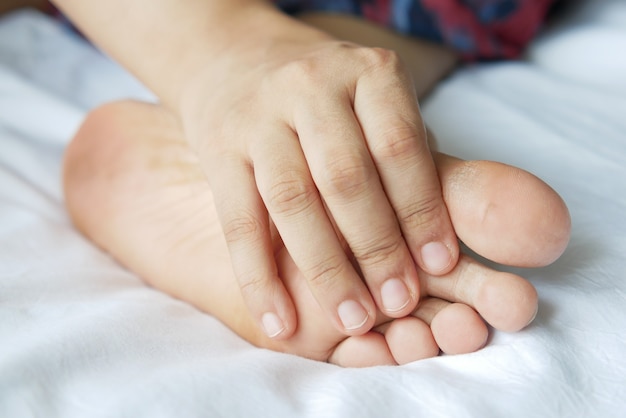 Close up on women feet and hand massage on injury spot