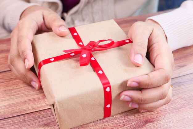 close up of women hand holding a gift box