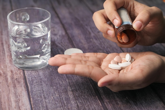 Photo close up of women hand taking medicine