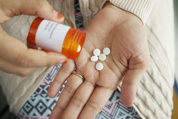 Close up of women hand taking pills