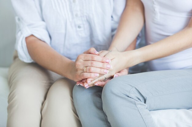 Close-up of women holding hands